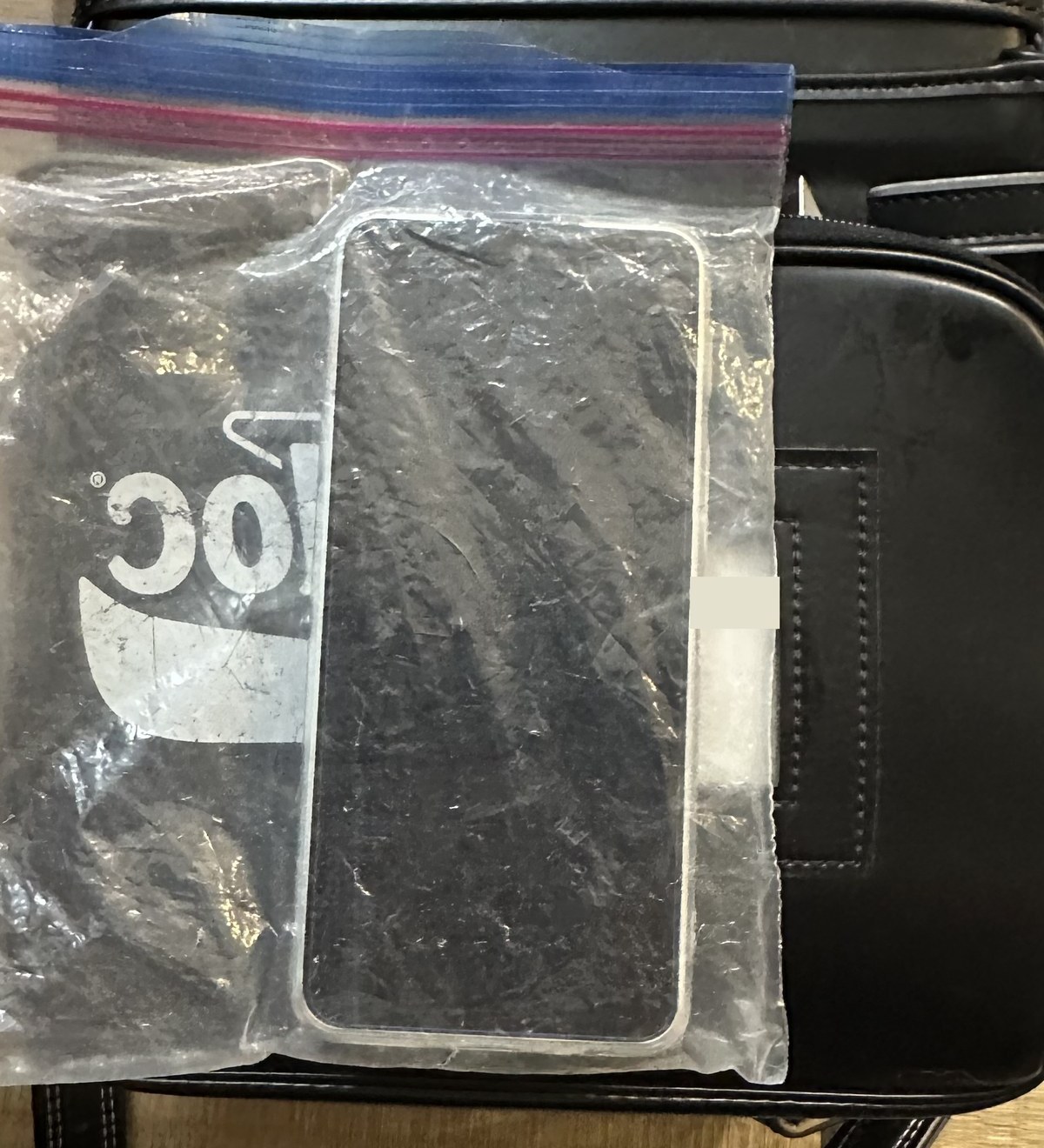 ジップロックに入れたnubia S2Rを、ランドセルのサイドポケットに入れているところ